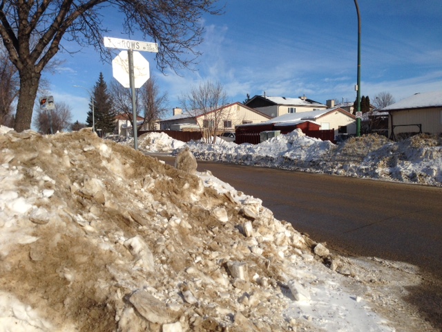 Snowbanks tower over the road in some Winnipeg areas. 
