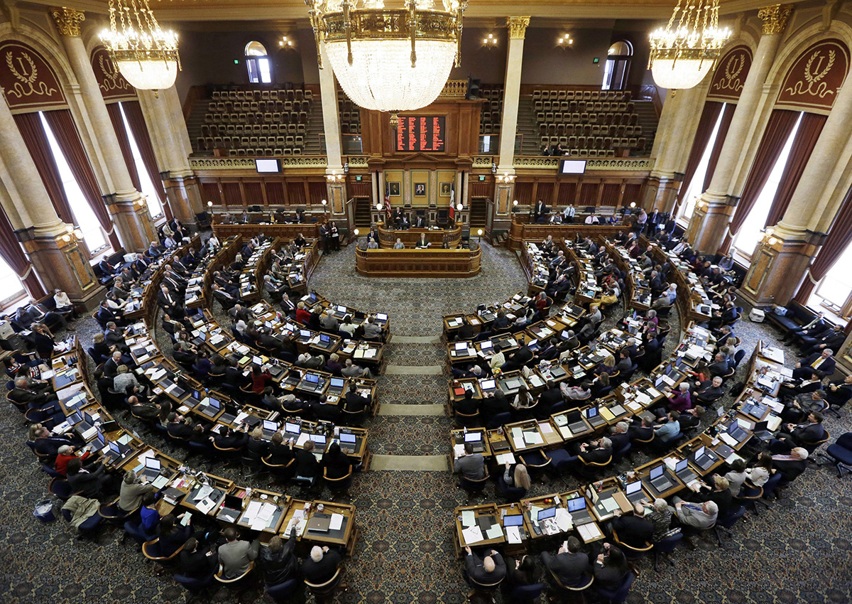 In this Jan. 13, 2014, file photo, state representatives work in the Iowa House on the opening day of the Iowa Legislature at the Statehouse in Des Moines, Iowa. I.
