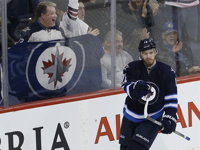 Winnipeg Jets' Bryan Little celebrates one of his two goals against the St. Louis Blues on Saturday.