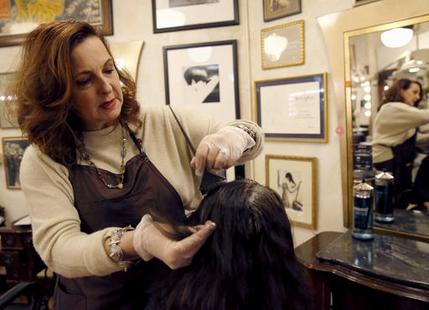 Karen Gordon works on the hair of a client at J. Gordon Designs in Chicago in this Dec. 29, 2016, photo.