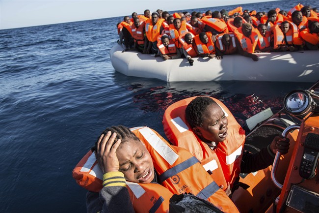 A migrant reacts to being rescued by the MV Aquarius, after 191 people and two corpses were recovered Friday Jan. 13, 2017, from international waters in the Mediterranean Sea about 22 miles north of Sabrata, Libya.