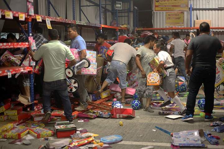 People pick up toys as they loot a store during a protest in the port of Veracruz, Mexico, on January 4, 2017, related to a 20 percent gasoline price increase. ( ILSE HUESCA/AFP/Getty Images)