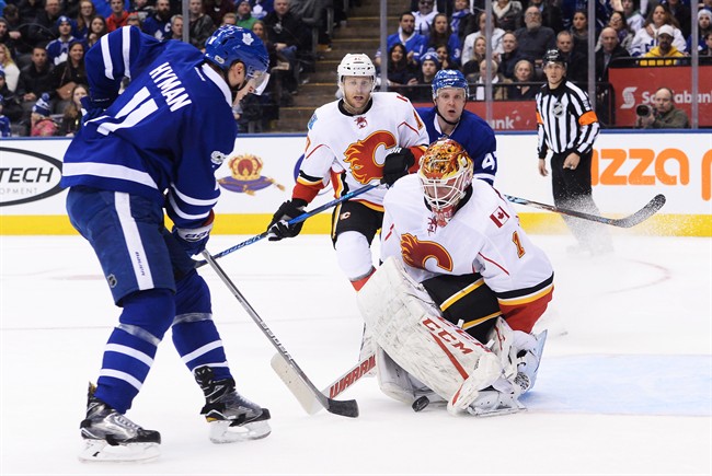 Toronto Maple Leafs centre Zach Hyman (11) scores on Calgary Flames goalie Brian Elliott (1) during second period NHL hockey action in Toronto on Monday, January 23, 2017. 