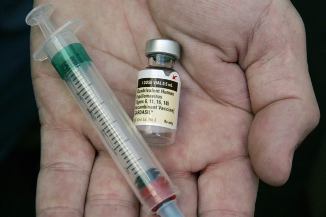 FILE - In this Aug. 28, 2006 file photo, a doctor holds a vial of the human papillomavirus (HPV) vaccine Gardasil in his Chicago office. HPV vaccination can prevent cervical cancer.