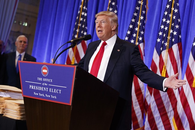 President-elect Donald Trump, accompanied by Vice President-elect Mike Pence, speaks during a news conference in the lobby of Trump Tower in New York, Wednesday, Jan. 11, 2017.