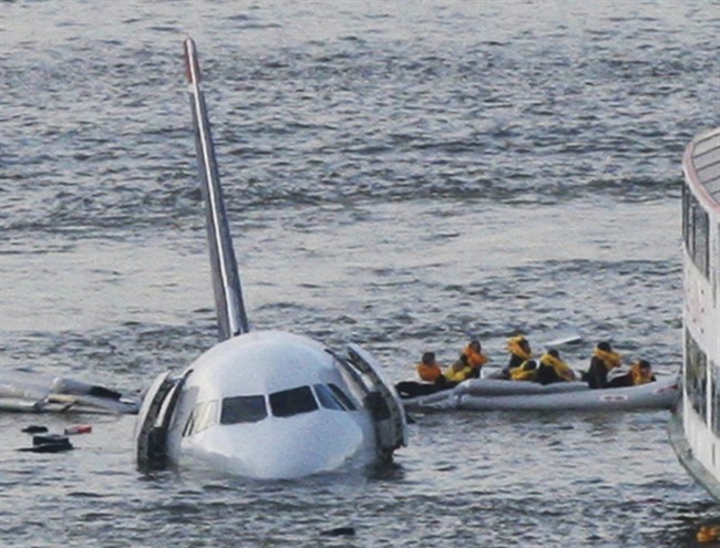 In this Jan. 15, 2009 file photo, passengers in an inflatable raft move away from an Airbus 320 US Airways aircraft that has gone down in the Hudson River in New York. Eight years after the miracle landing on the Hudson River, thousands of birds have been killed at New York City airports to avoid more strikes. But the slaughter has come at great expense and included many smaller species experts say are unlikely to cause a disaster. (AP Photo/Bebeto Matthews, File)
