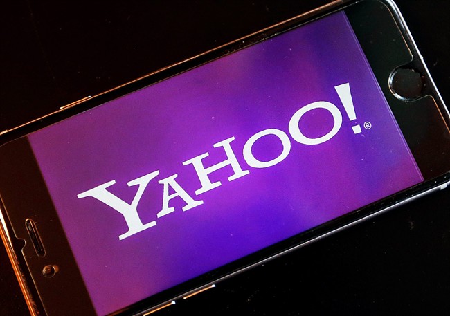 FILE - In this Dec. 15, 2016, file photo, the logo of Yahoo appears on a smartphone in Frankfurt, Germany. (AP Photo/Michael Probst, File).