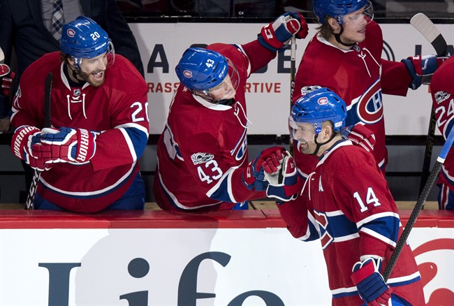 Montreal Canadiens centre Tomas Plekanec (14) celebrates his goal against the Calgary Flames with teammates left wing Daniel Carr (43) and defenceman Zach Redmond (20) during second period NHL hockey action Tuesday, January 24, 2017 in Montreal.