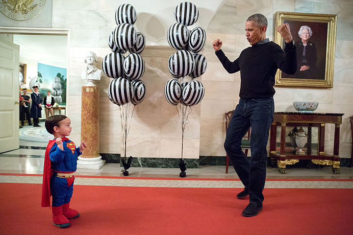 “The President was about to welcome local children for Halloween trick-or-treating when he ran into Superman Walker Earnest, son of Press Secretary Josh Earnest, in the Ground Floor Corridor of the White House. ‘Flex those muscles,’ he said to Walker.” .