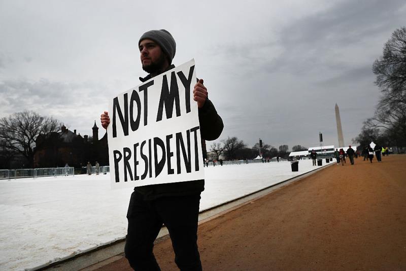 A protester walks on the National Mall for the inauguration of Donald Trump on January 20, 2017 in Washington, DC. Washington and the entire nation are preparing for the transfer of the United States presidency later today as Donald Trump is sworn is as the 45th president Friday.
