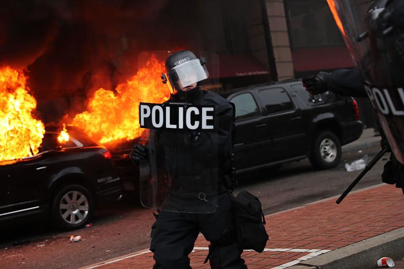 Police and demonstrators clash in downtown Washington after a limo was set on fire following the inauguration of President Donald Trump on January 20, 2017 in Washington, DC.