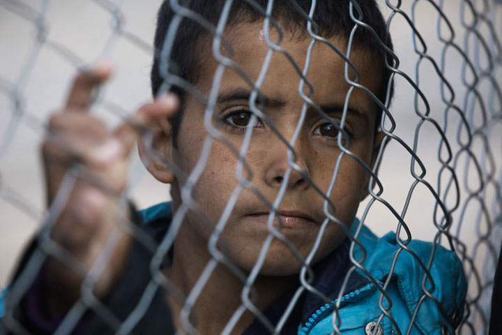 A refugee boy who fled the Iraqi city of Mosul due to the fighting between government forces and Islamic State (IS) group jihadists, waits to receive aid at the UN-run al-Hol refugee camp in Syria's Hasakeh province, on January 29, 2017.
