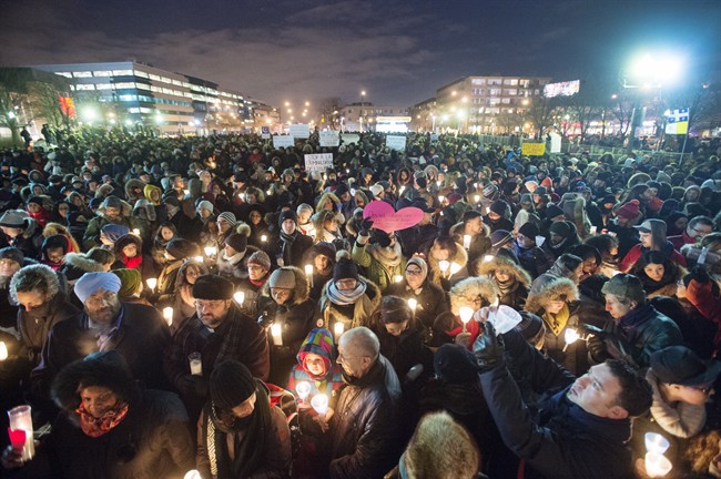 People attend a vigil for victims of the mosque shooting in Quebec City Monday, January 30, 2017 in Montreal.