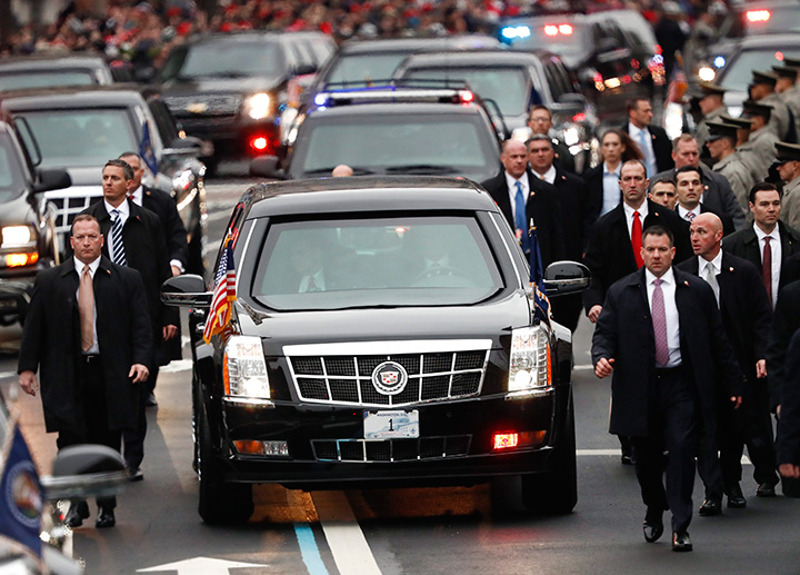 Members of President Donald Trump's Secret Service detail walk with the First Family's motorcade vehicle as they move alone the Inauguration Day Parade Route in Washington, Friday, Jan. 20, 2017, after Donald Trump was sworn in as the 45th president of the United States.