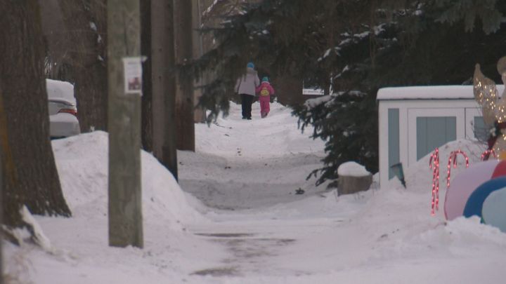 Two people walk on a snow-covered sidewalk in Edmonton on Jan. 12, 2017.