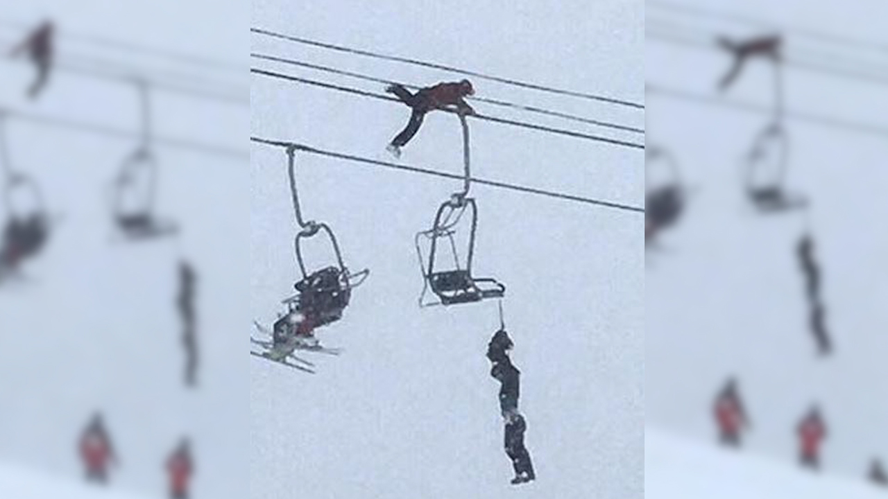 Man climbs Colorado ski lift to rescue unconscious friend dangling by
neck