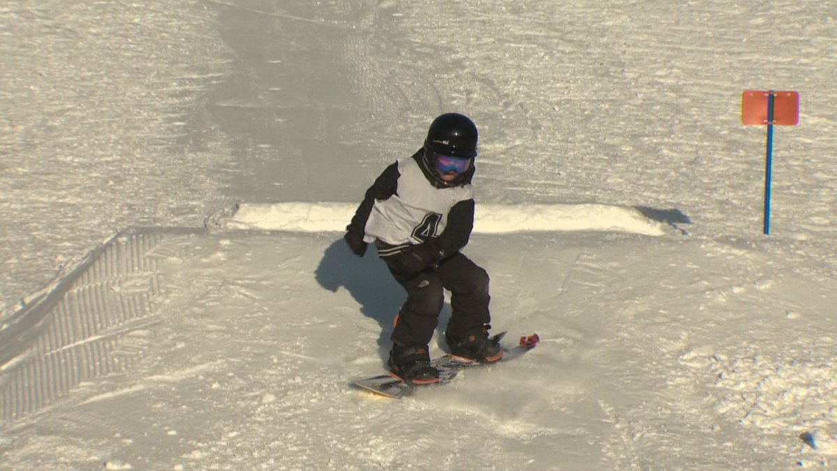 Young snowboarders show off their skills in a freestyle competition.