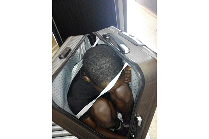 In this photo released by the Spanish Guardia Civil on Tuesday, Jan. 3, 2017, a 19-year-old migrant from Gabon is photographed in a suitcase, in Ceuta, Spain. 