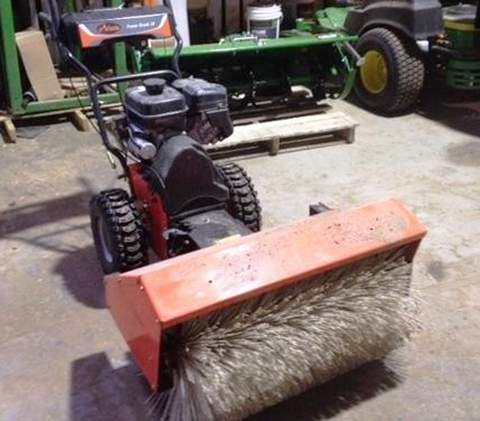 The sweeper, an Ariens 24” model 920014, has an “NCE Enterprises Inc.” decal on it.