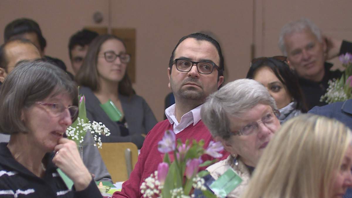 Syrian newcomer Mohammed Bakhash listens to speeches at the MCAF Community Connections Appreciation Night  .