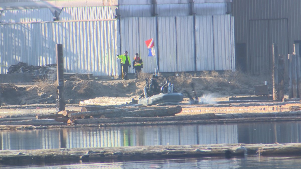 RCMP divers work to recover the body of a boom boat operator at the Kelowna Tolko mill Tuesday morning after the vessel sank Monday evening. 