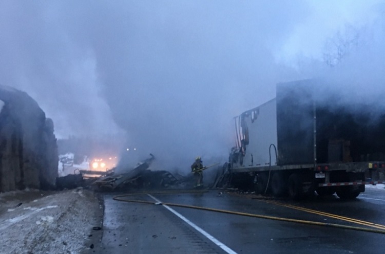 Emergency crews work to extinguish flames on Highway 17a Monday morning. 