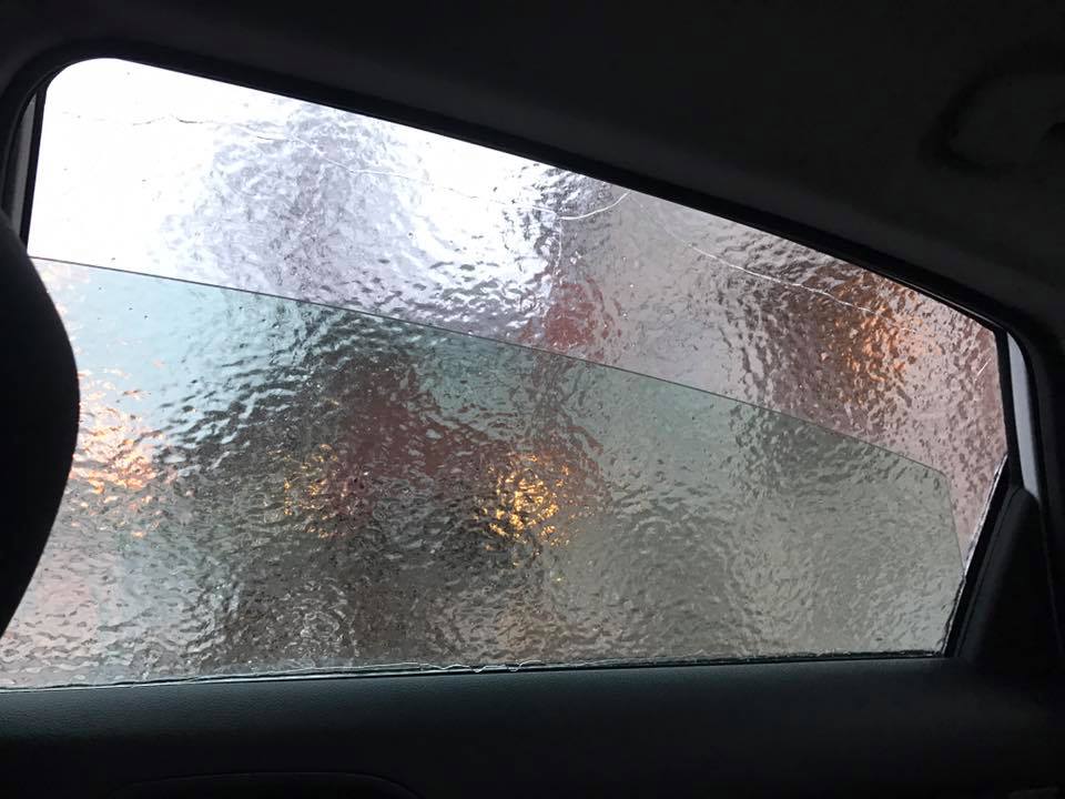 Winding down the car window.