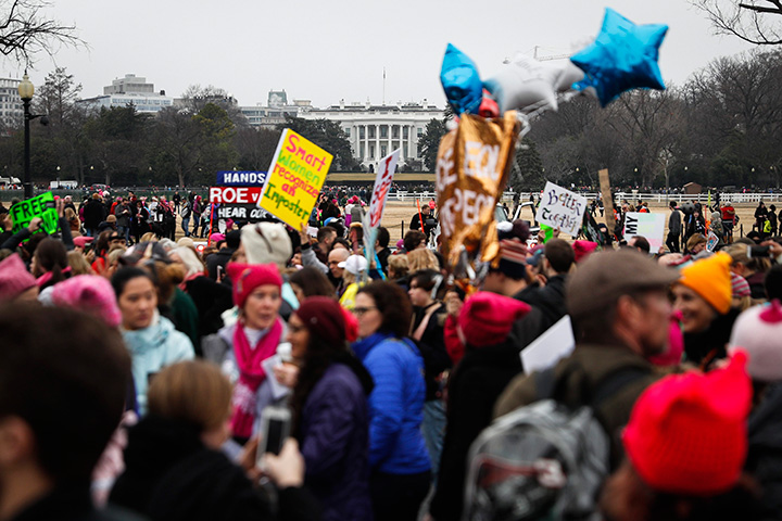 Protesters walk across Constitution Avenue near the White House for the Women’s March on Washington during the first full day of Donald Trump’s presidency, Saturday, Jan. 21, 2017 in Washington.