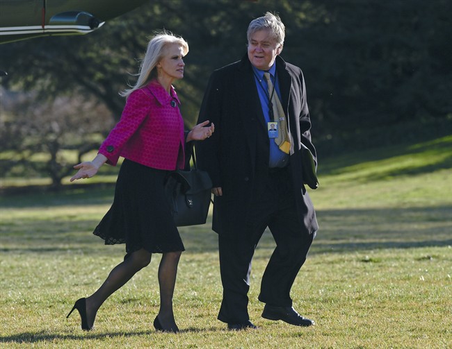 In this Jan. 26, 2017, photo White House counselor Kellyanne Conway, left, and senior adviser Steve Bannon, right, walk on the South Lawn of the White House in Washington, after returning via Marine One from a trip to Philadelphia with President Donald Trump.