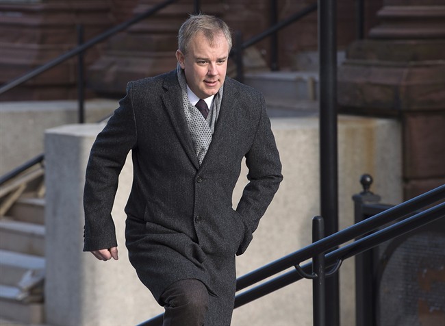 A court appearance for two Halifax men charged with assaulting Dennis Oland in a New Brunswick prison was delayed Thursday.