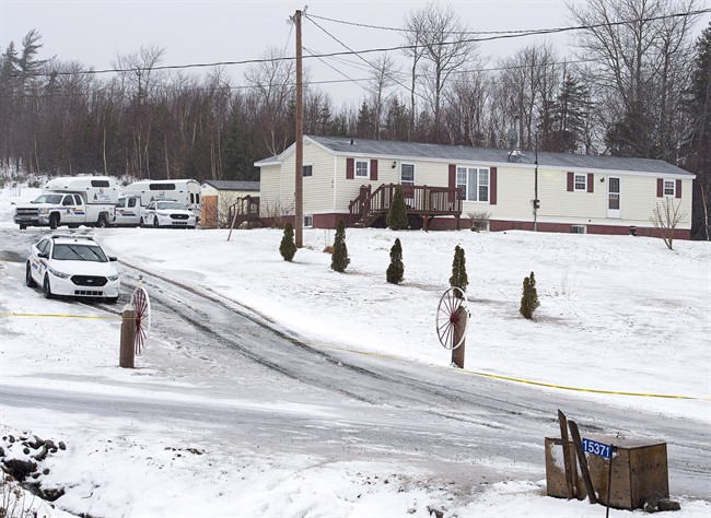 Police vehicles are seen outside a residence in Upper Big Tracadie, N.S. on Wednesday, Jan. 4, 2017. 