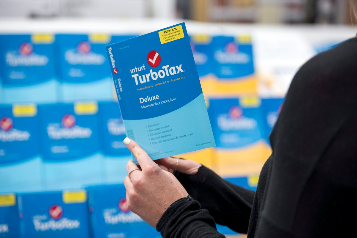 A person holds a version of TurboTax software.