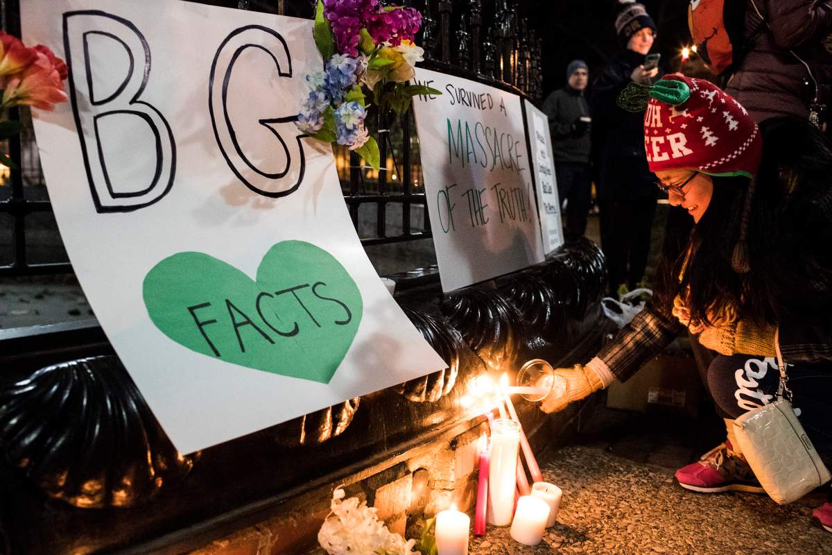 Summer Wei lights a candle during a Bowling Green “massacre” remembrance gathering on Friday, Feb. 3, 2017, at Fountain Square Park in Bowling Green, Ky.