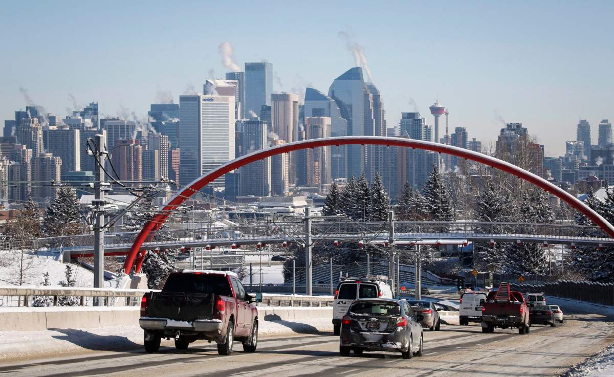 Calgary traffic moving along against a downtown skyline.