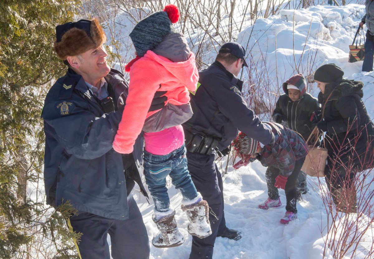 With open arms, Mounties help refugees who walked across the Canadian ...