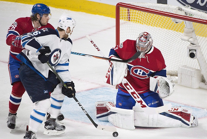 Montreal Canadiens goaltender Carey Price makes a save against Winnipeg Jets' Shawn Matthias (16) as Canadiens' Nathan Beaulieu (28) defends during first period NHL hockey action in Montreal, Saturday, February 18, 2017. THE CANADIAN PRESS/Graham Hughes