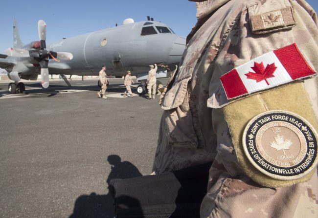 Members of the Canadian Forces work on a CP140 Aurora surveillance plane at the Canadian Forces base in the Persian Gulf, Feb. 19, 2017.