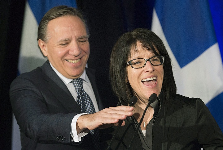Coalition Avenir Quebec (CAQ) leader Francois Legault adjusts the microphone for Sonia LeBel during a news conference in Montreal, Tuesday, February 21, 2017, where it was announced that she would become deputy chief of staff for the party. THE CANADIAN PRESS/Graham Hughes
