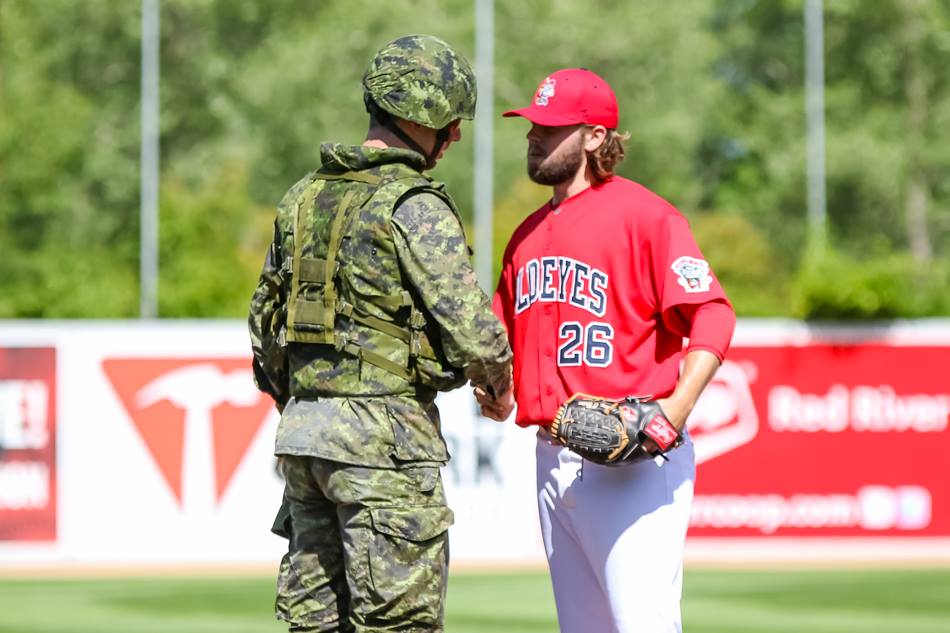 Winnipeg Goldeyes pitcher Mike O'Brien meets with a solider before the start of a game.