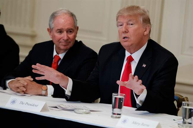 Blackstone CEO Stephen Schwarzman listens at left as President Donald Trump speaks during a meeting with business leaders in the State Dining Room of the White House in Washington, Friday, Feb. 3, 2017.