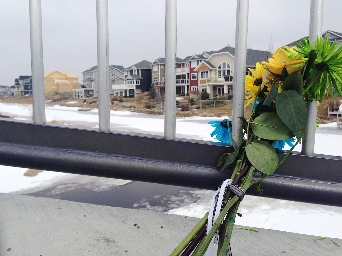 Flowers mark the spot near the tragic fall through the ice in Airdrie, Alta.