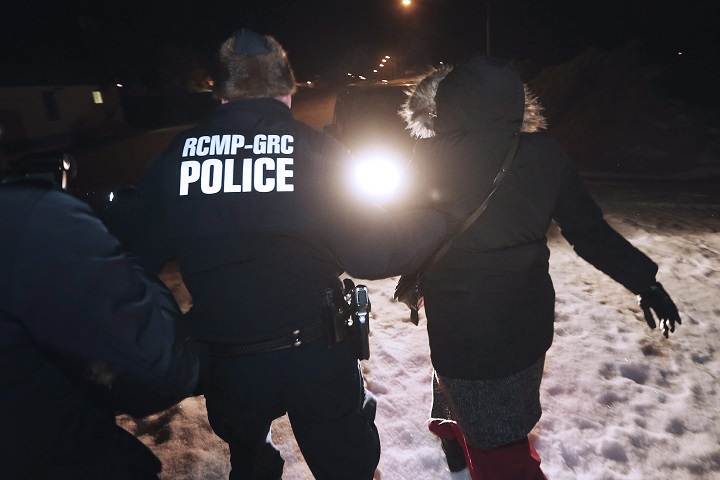 Early Sunday morning, February 26, 2016, a migrant from Somalia is arrested and detained by RCMP after crossing into Canada illegally from the United States by walking down a train track into the town of Emerson, where the migrant will seek asylum at Canada Border Services Agency. THE CANADIAN PRESS/John Woods