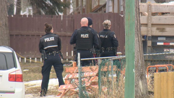 Officers stand together in the 1300 block of Athol Street. Regina police say a man was found with a gunshot wound in the 1300 block of Athol Street on Feb. 22, 2017.