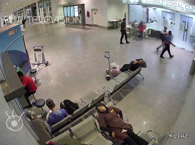 In this image made from Feb. 13, 2017, airport closed circuit television video and provided by Fuji Television, Kim Jong Nam, second from right, exiled half-brother of North Korea\’s leader Kim Jong Un, walks with an airport security official towards a medical clinic, top right, after he was attacked at Kuala Lumpur International Airport, Malaysia.