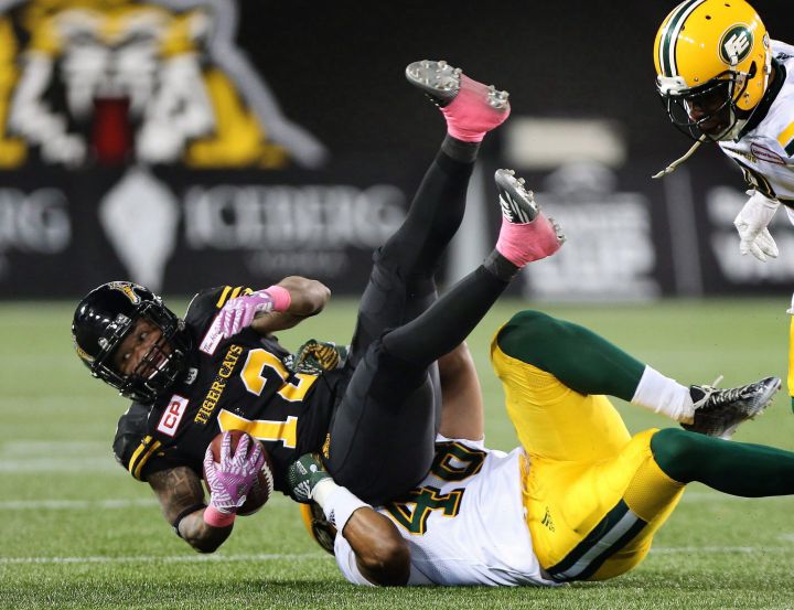 Hamilton Tiger-Cats Kendial Lawrence(12) is tackled by Edmonton Eskimos linebacker Blair Smith (48) during the first-half of CFL football action in Hamilton on Friday, October 28, 2016.