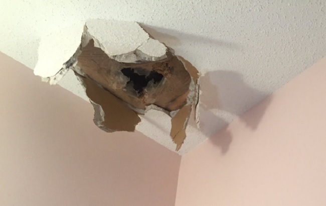 The damage inside a Calgary home where ice from a a plane smashed through the ceiling.