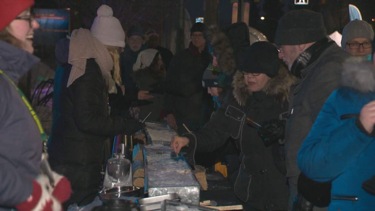 Edmontonians enjoy maple syrup on ice at the Flying Canoe Volant Festival.