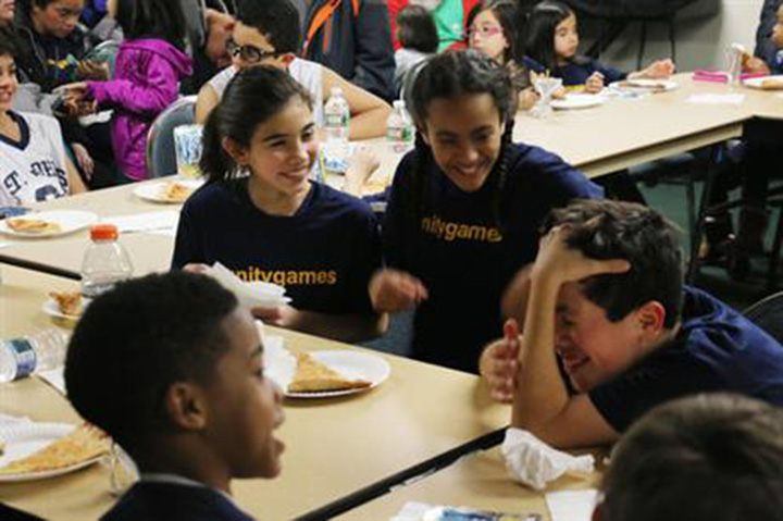 In this Friday, Feb. 10, 2017 photo, Kayla Martel, centre right, and her Grade 5 teammates eat pizza after forfeiting the rest of their basketball season in the teachers’ lounge at St. John the Apostle School in Clark, N.J. 