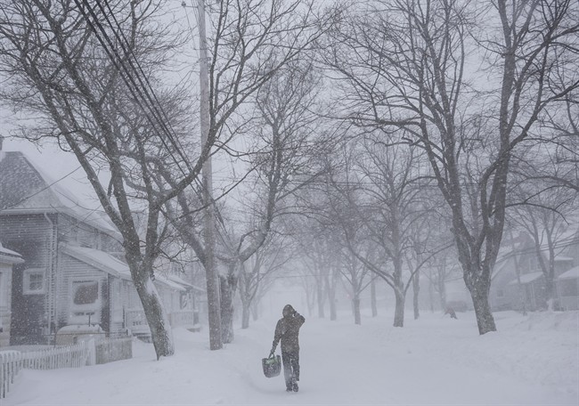 A man walks down the middle of Agricola Street in Halifax as a major winter storm blasts the Maritimes on Monday, Feb. 13, 2017. 