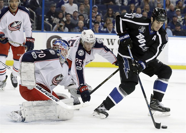 Tampa Bay Lightning centre Brian Boyle (11) takes a pass in front of Columbus Blue Jackets goaltender Joonas Korpisalo (70) and William Karlsson (25) during the second period of an NHL hockey game Friday, Jan. 13, 2017, in Tampa, Fla. The Toronto Maple Leafs have plugged a year-long hole at the fourth-line centre spot, swinging a trade with the Lightning for Boyle on Monday afternoon. 
